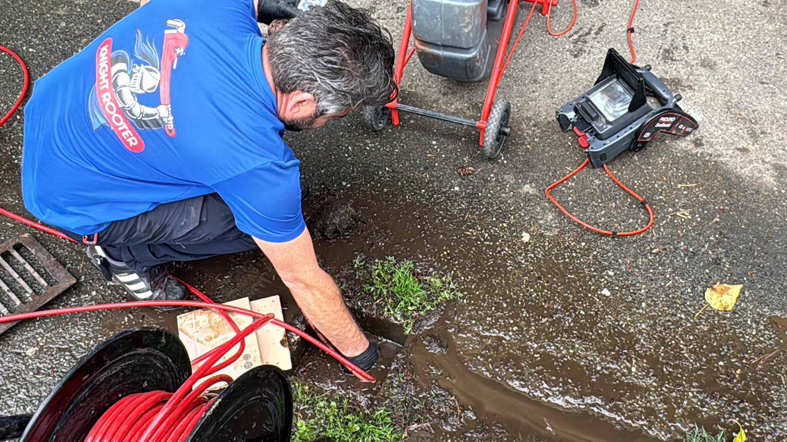 A Knight Rooter plumber performing a storm drain camera inspection