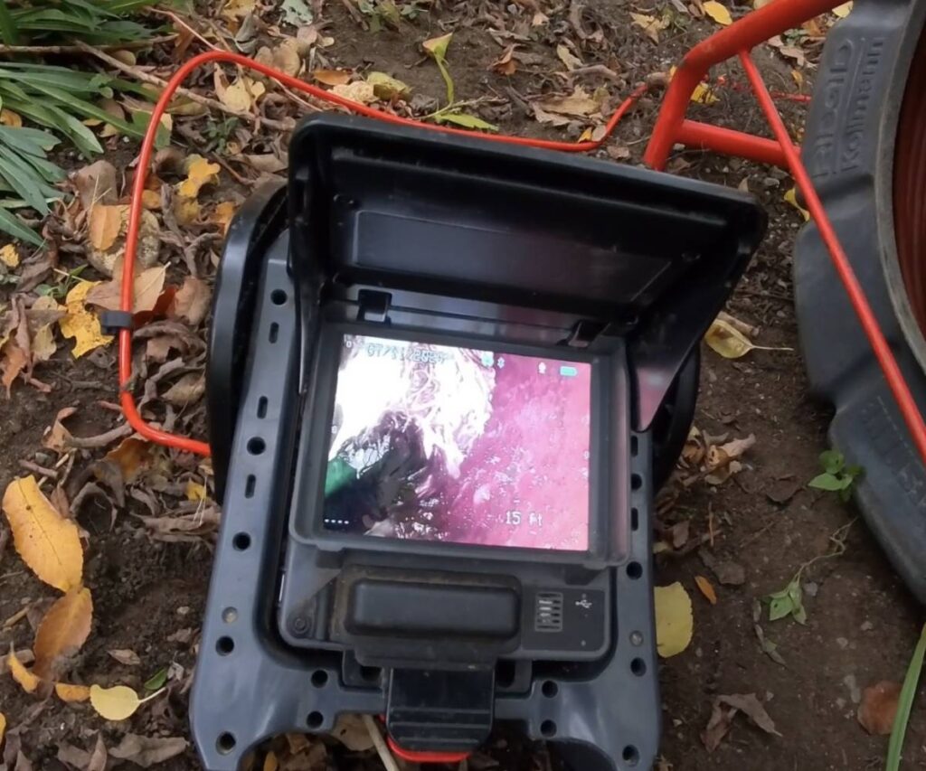 A KnightRooter professional performing a wireless sewer camera inspection.