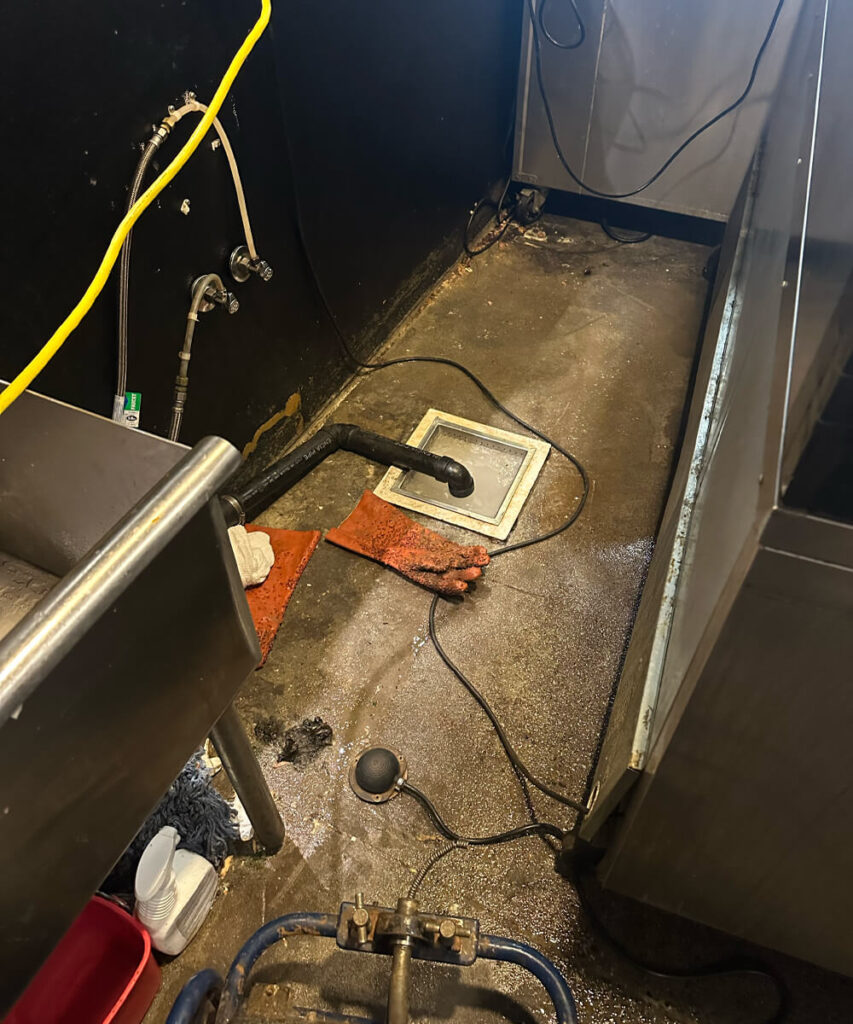 Close-up of grease accumulation in a kitchen drain, identified by a sewer camera inspection.  