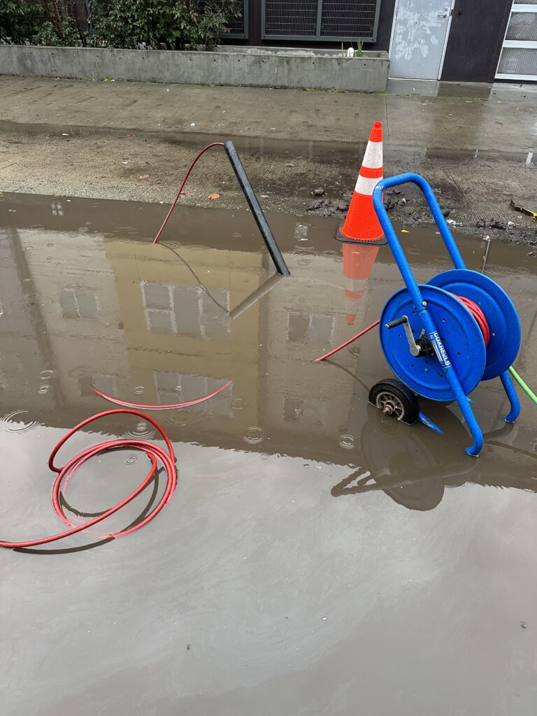 Plumbing tools on a flooded street 